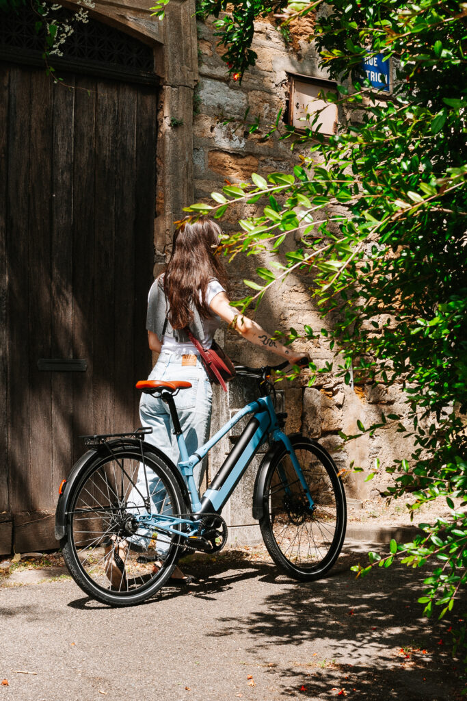 Femme en balade à vélo électrique Urban Boost REF Bikes, idéal pour proposer des vélos à vos clients hôteliers